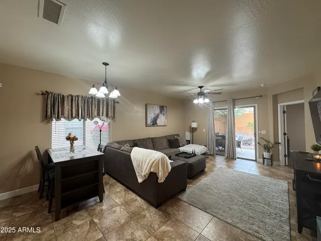a living room with furniture chandelier and a chandelier