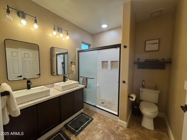 a bathroom with a sink toilet and mirror