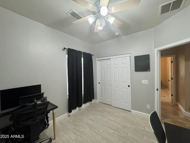 a bedroom with a bed and a television