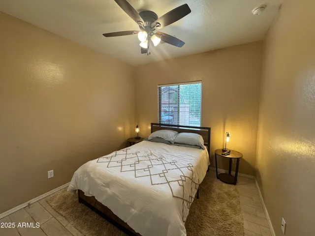 a bedroom with a bed and a chandelier