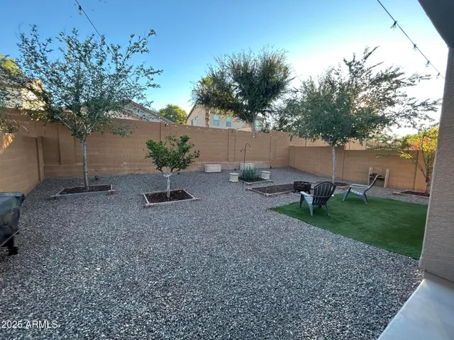 a backyard of a house with table and chairs