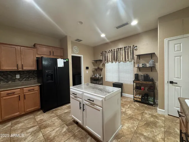 a kitchen that has a sink cabinets and stainless steel appliances