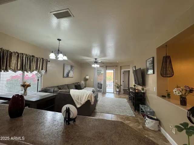 a living room with furniture ceiling fan and a rug