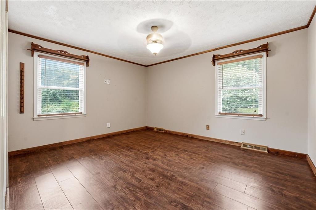 399 Donahoo Road Southeast Silver Creek, GA 30173 - Photo 12 of 22 a view of an empty room with wooden floor and a window