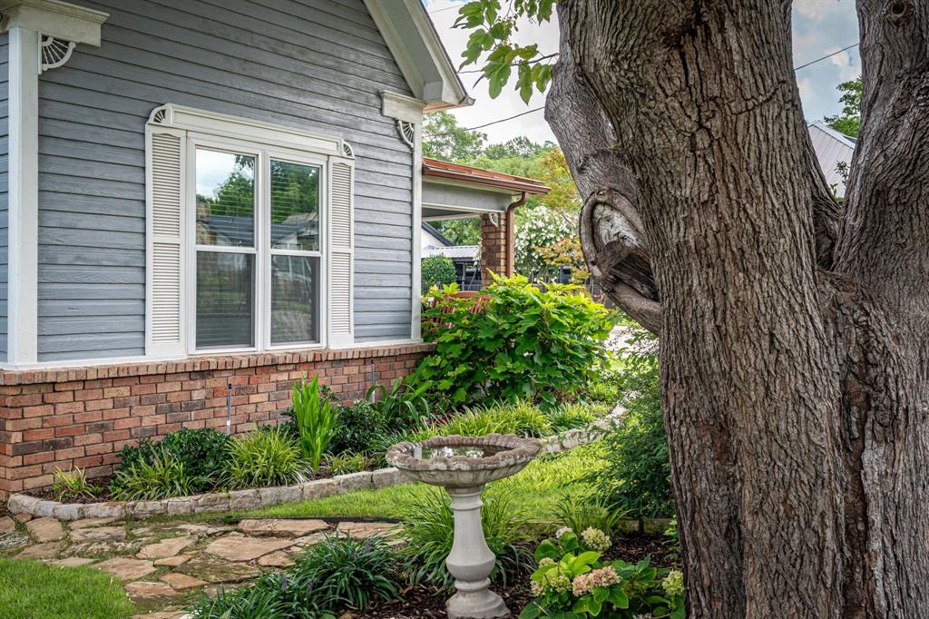 9121 6th Street Frisco, TX 75033 - Photo 21 of 27 a front view of a house with garden