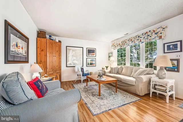 a living room with furniture large window and a table