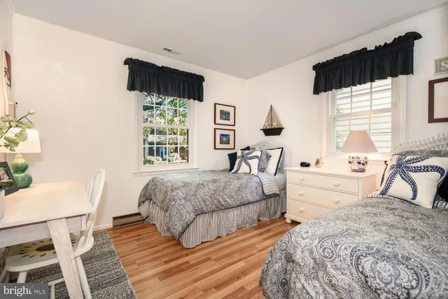 a bedroom with a bed a mirror and a window