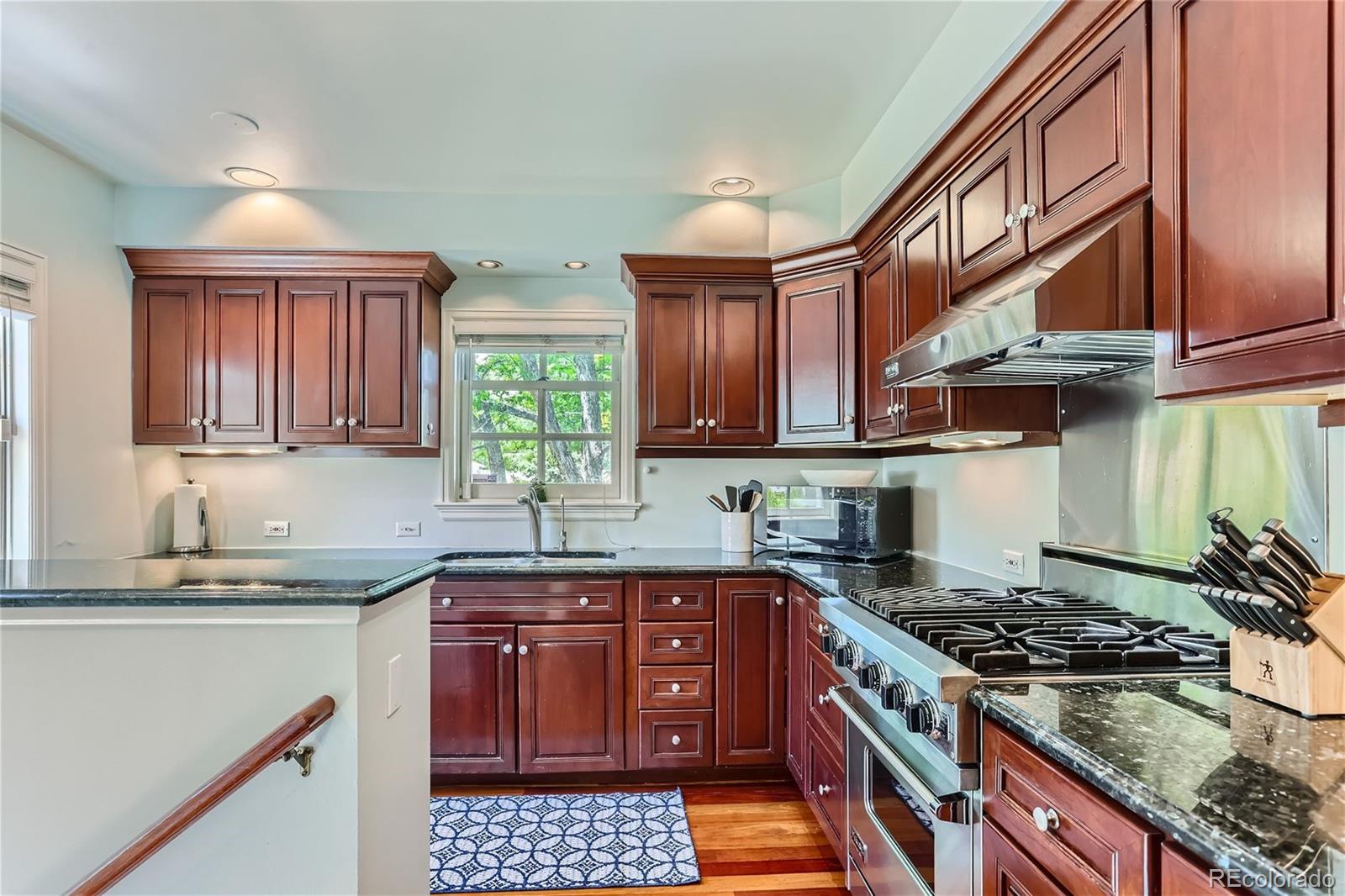 753 Cherry Street Denver, CO 80220 - Photo 11 of 37 a kitchen with stainless steel appliances granite countertop a stove and a sink