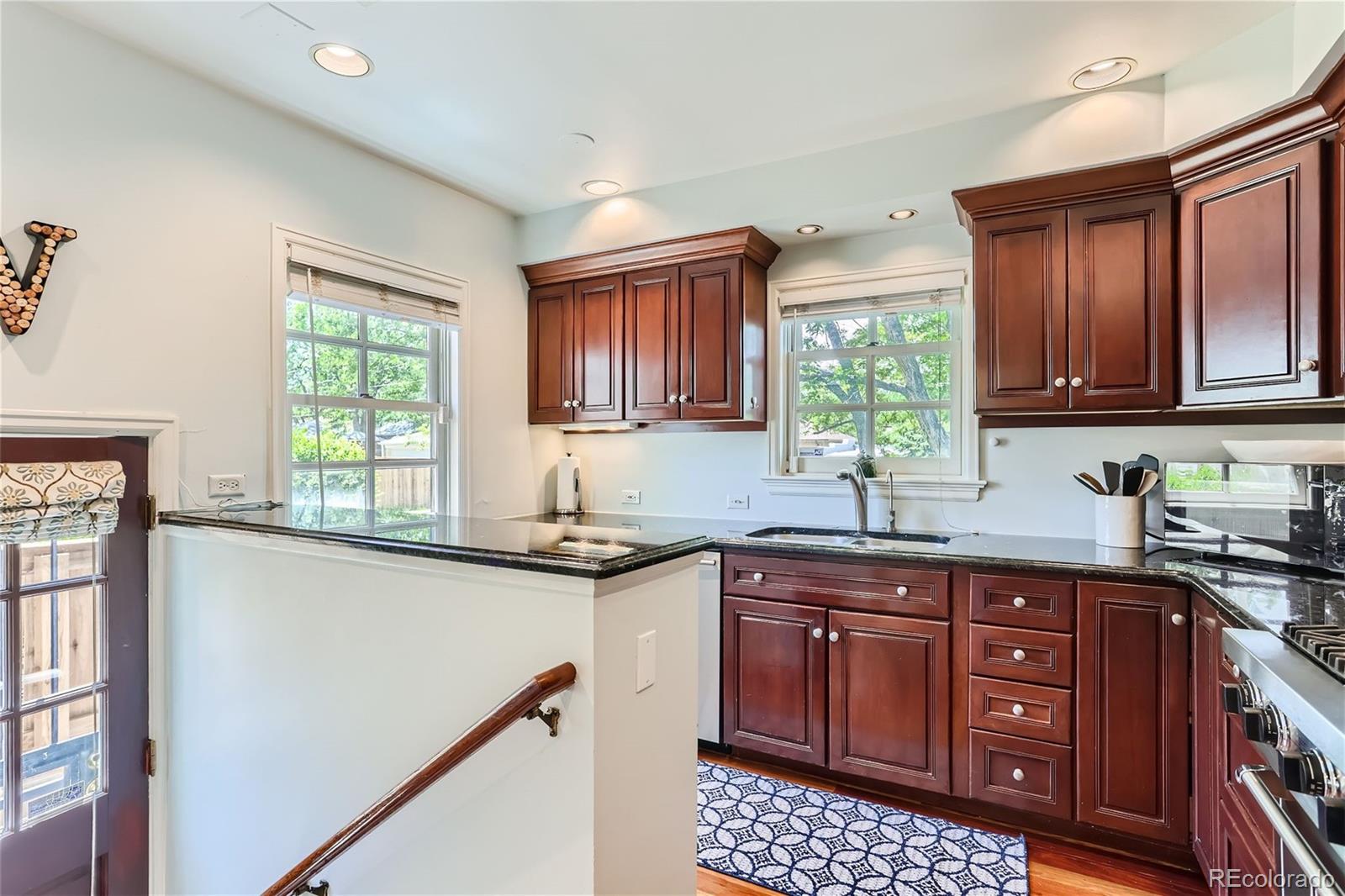 753 Cherry Street Denver, CO 80220 - Photo 12 of 37 a kitchen with stainless steel appliances granite countertop a stove a sink and a microwave