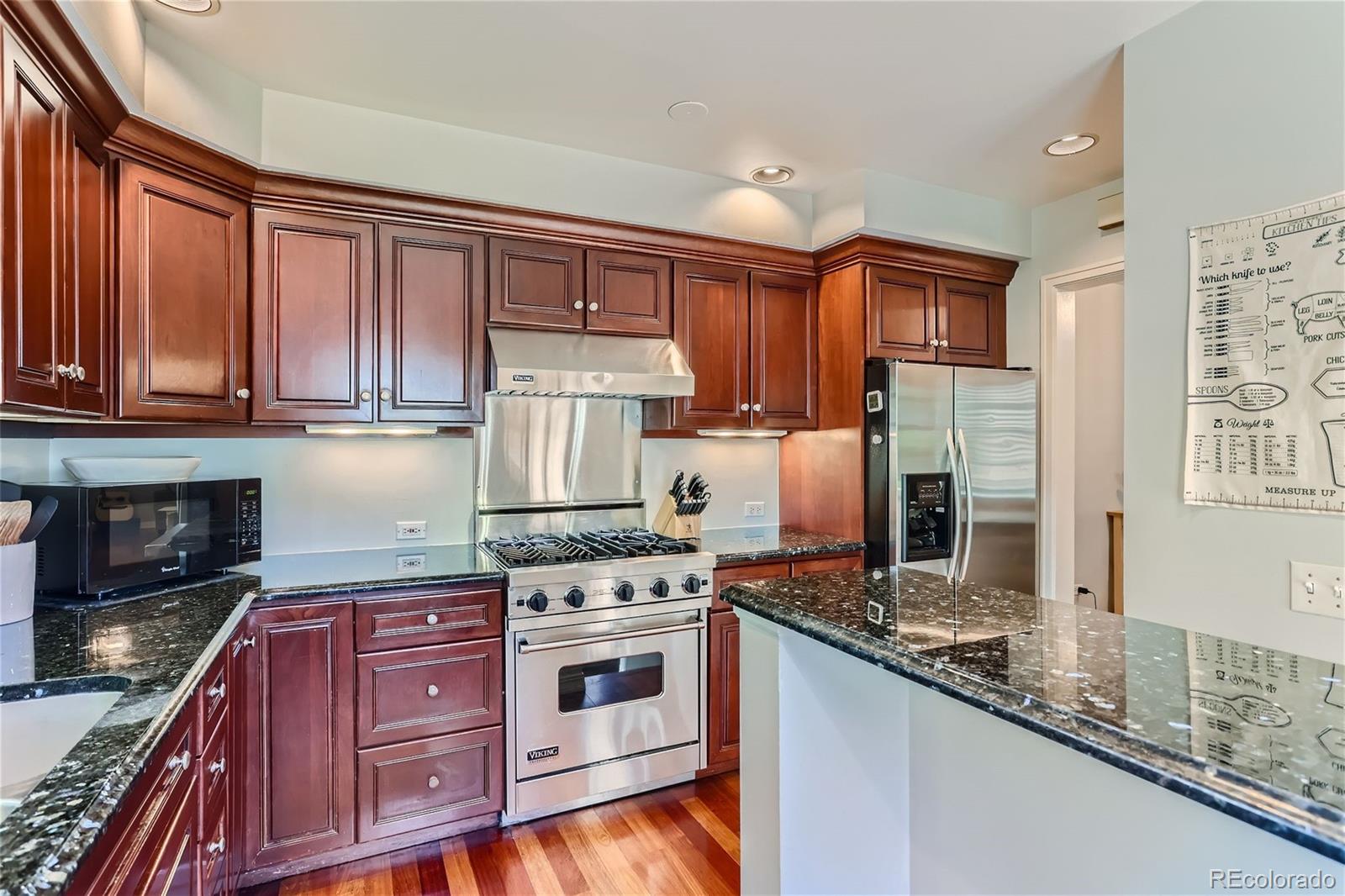 753 Cherry Street Denver, CO 80220 - Photo 13 of 37 a kitchen with granite countertop a stove top oven sink and cabinets