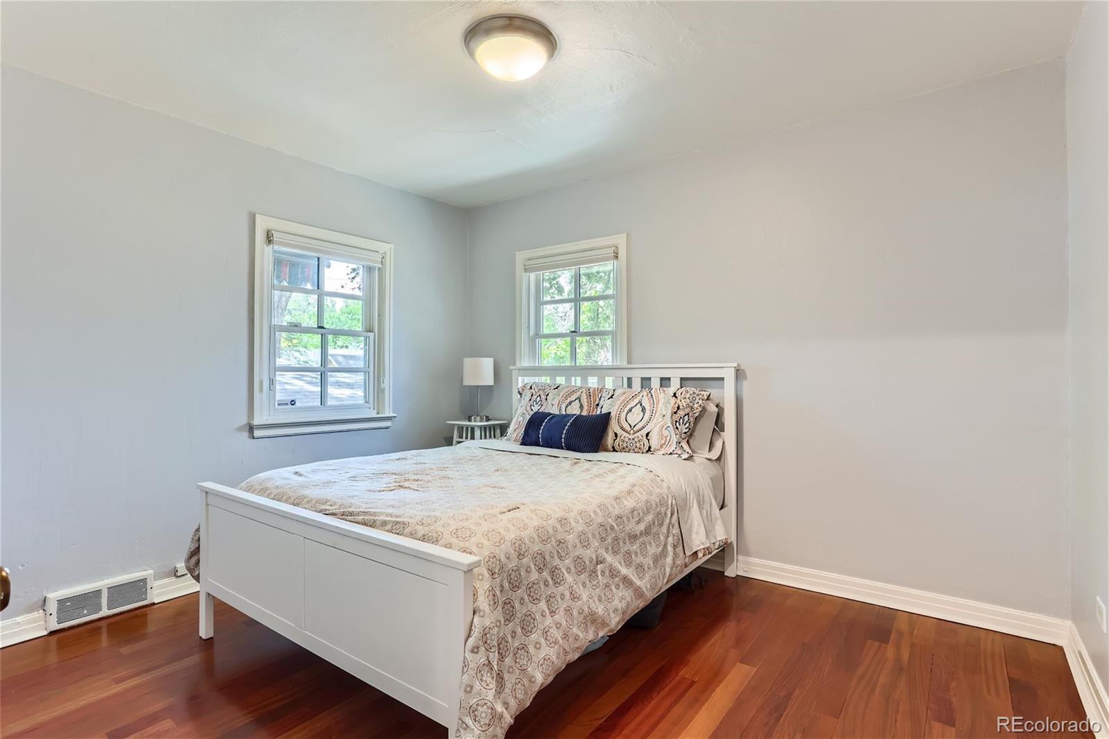 753 Cherry Street Denver, CO 80220 - Photo 17 of 37 a bed sitting in a spacious bedroom next to a window