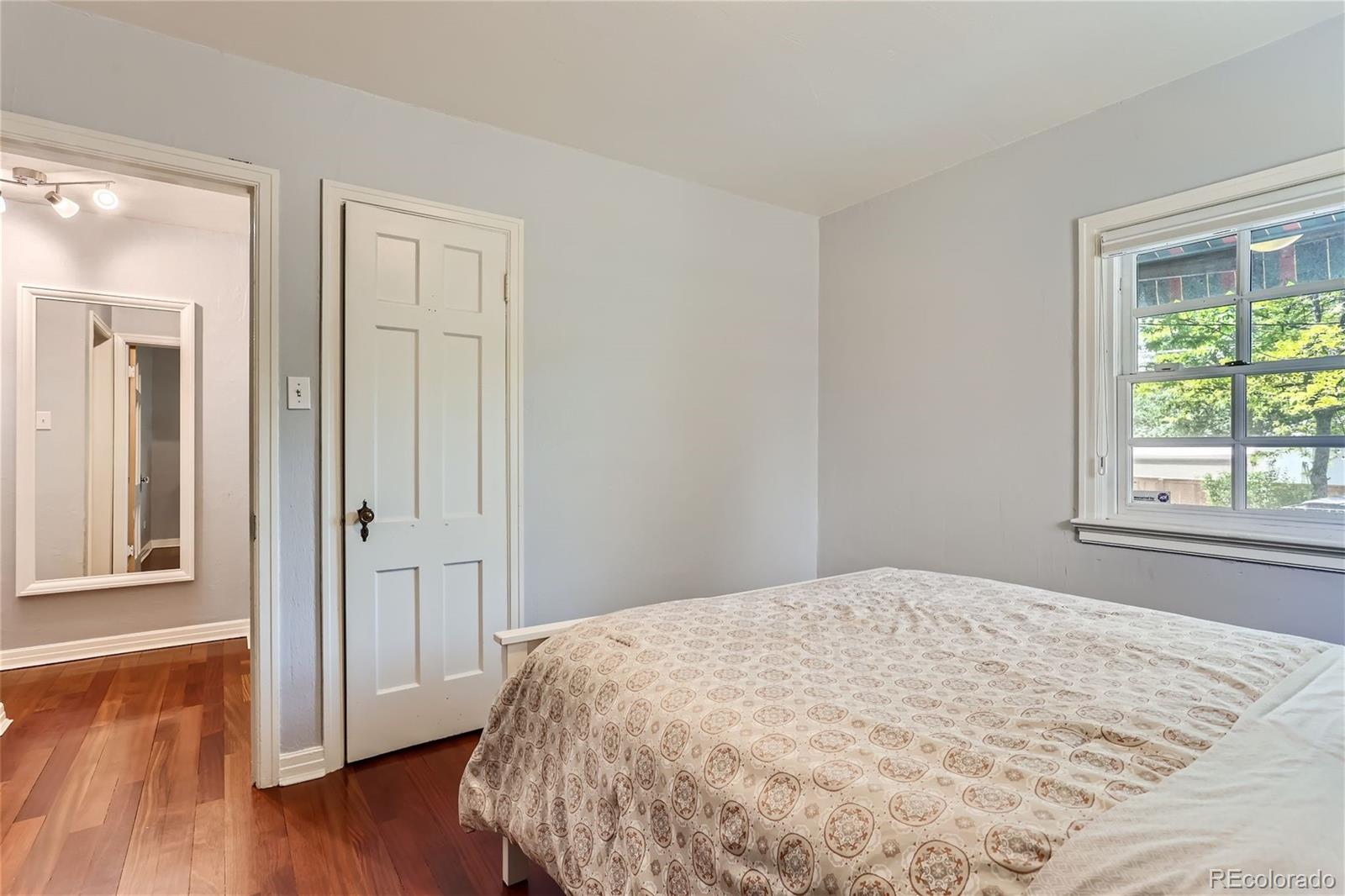 753 Cherry Street Denver, CO 80220 - Photo 18 of 37 a view of a bedroom with wooden floor and front door