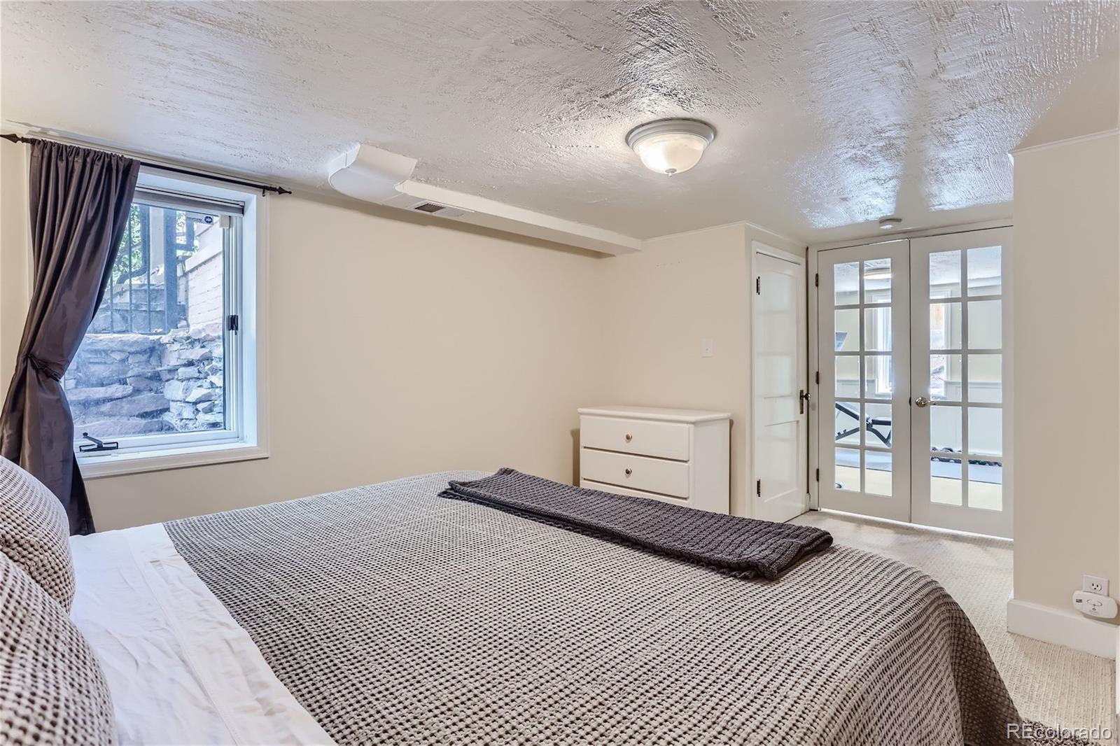 753 Cherry Street Denver, CO 80220 - Photo 21 of 37 a bedroom with a large bed and a window