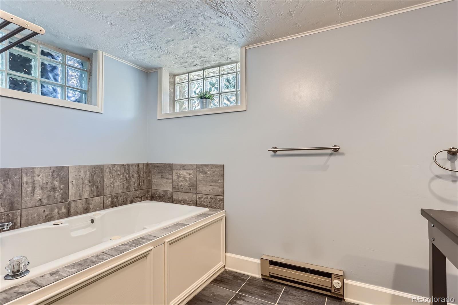 753 Cherry Street Denver, CO 80220 - Photo 23 of 37 a bathroom with a tub and sink