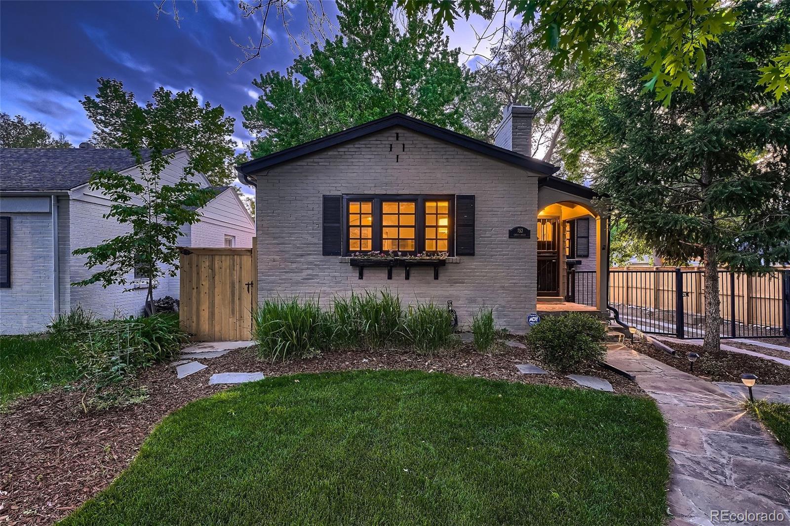 753 Cherry Street Denver, CO 80220 - Photo 3 of 37 a front view of a house with a yard