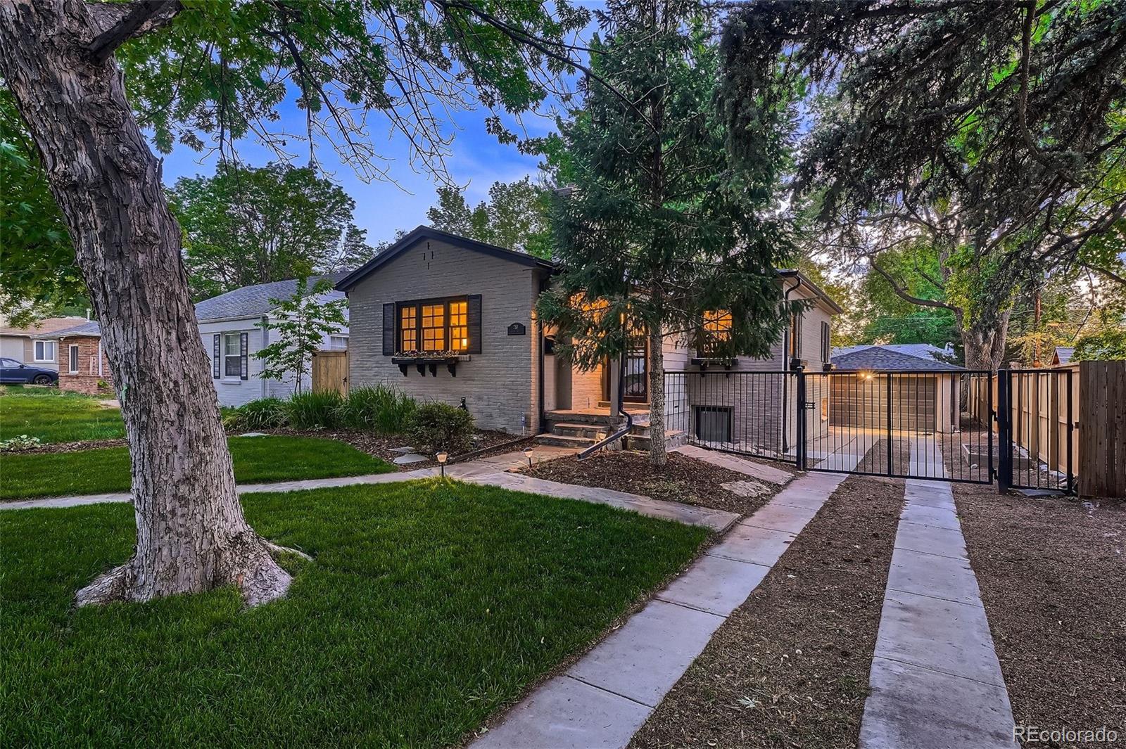 753 Cherry Street Denver, CO 80220 - Photo 4 of 37 a front view of a house with a yard