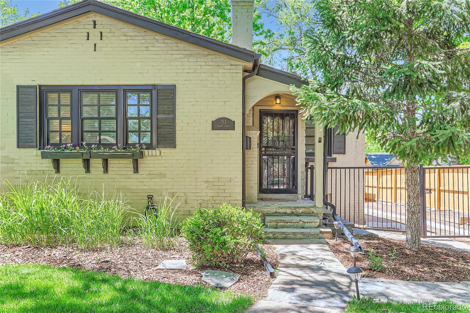 753 Cherry Street Denver, CO 80220 - Photo 6 of 37 a front view of a house with a yard