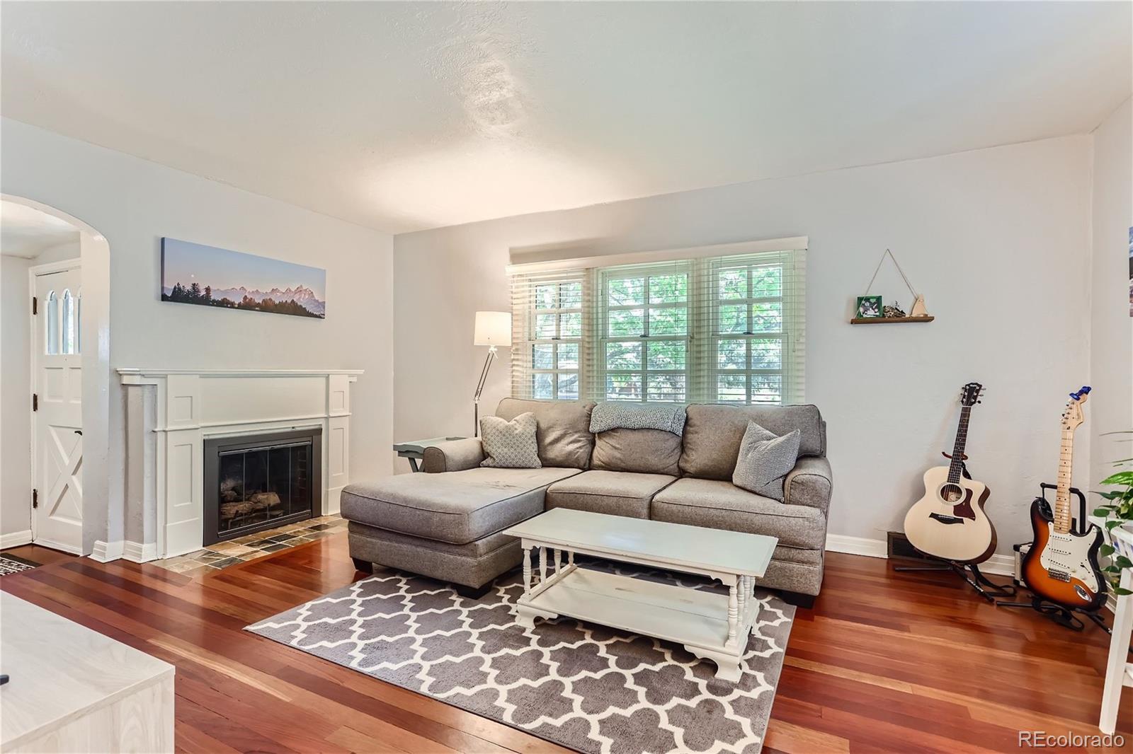 753 Cherry Street Denver, CO 80220 - Photo 8 of 37 a living room with furniture and a fireplace