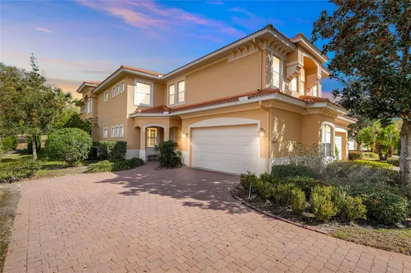 a front view of a house with a yard and a garage