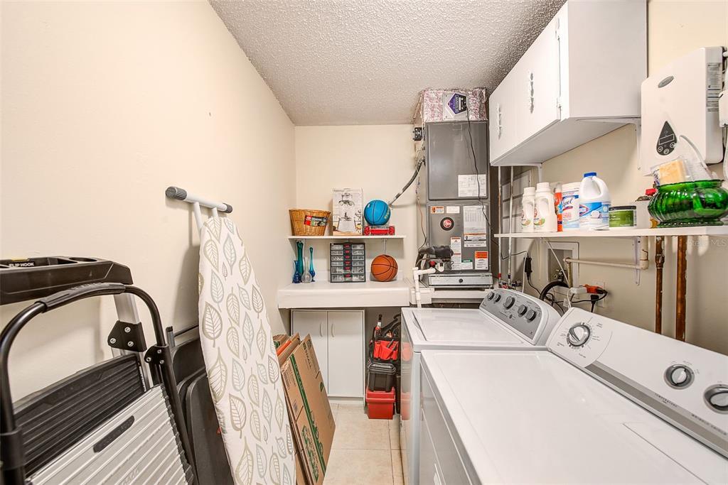2064 Sunset Point Road, Unit 73 Clearwater, FL 33765 - Photo 23 of 58 a storage room with washer and dryer