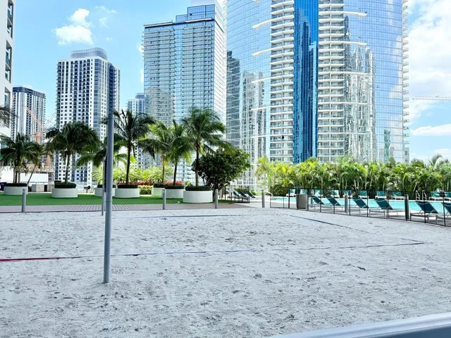 a view of a house with a yard and lawn chairs