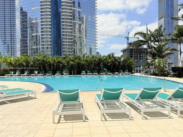 a view of a swimming pool and chairs in the patio