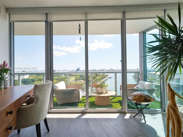 a living room with furniture and a floor to ceiling window