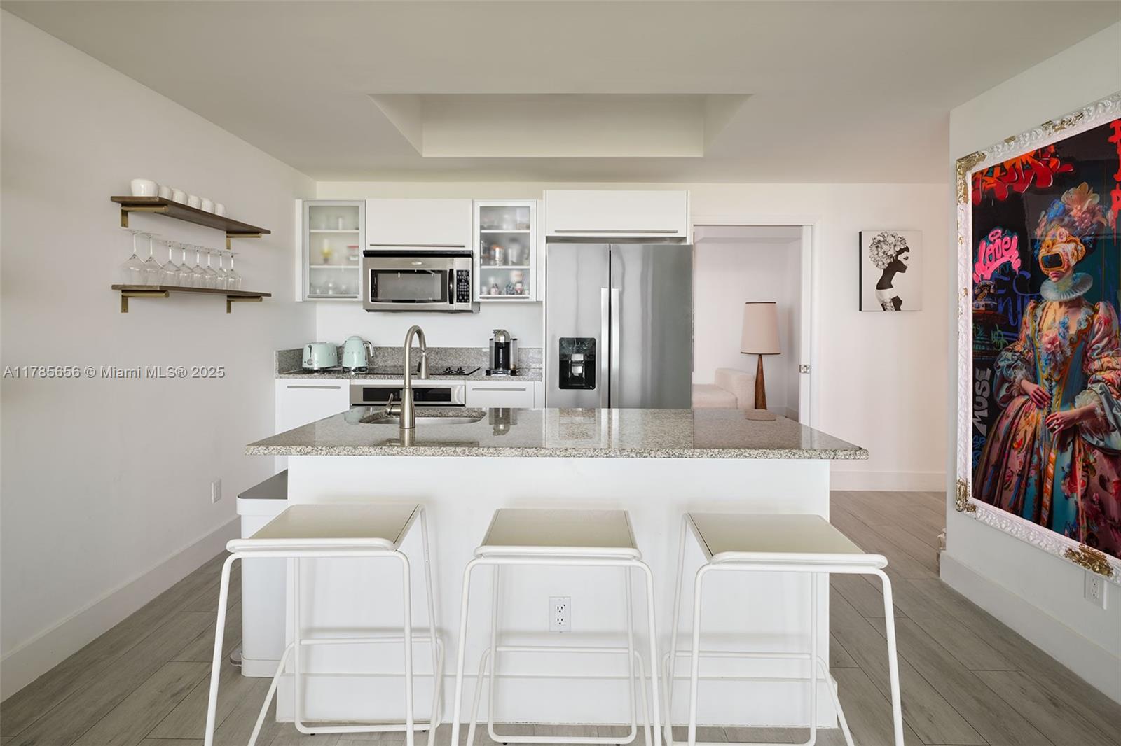 888 Biscayne Boulevard, Unit 1009 Miami, FL 33132 - Photo 6 of 15 a living room with stainless steel appliances furniture a fireplace and a flat screen tv