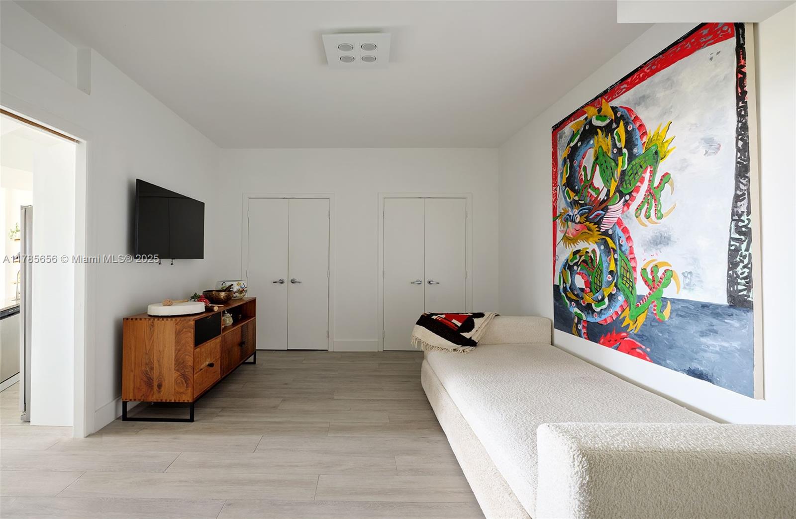 888 Biscayne Boulevard, Unit 1009 Miami, FL 33132 - Photo 10 of 15 a living room with furniture and a flat screen tv