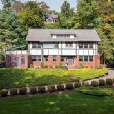 a front view of a house with a yard table and chairs