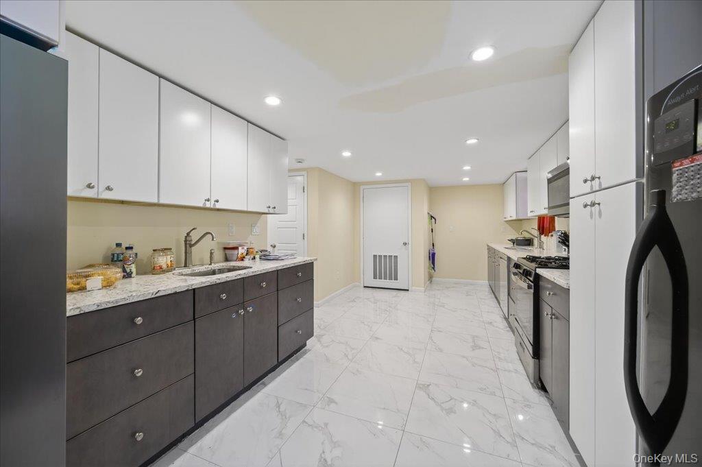 431 Gate Hill Coop Road Stony Point, NY 10980 - Photo 11 of 41 Kitchen featuring white cabinets, black appliances, recessed lighting, dark brown cabinetry, and light marble finish floors