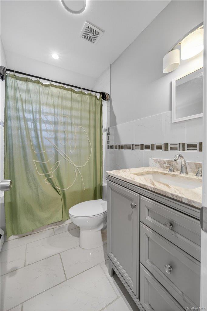 431 Gate Hill Coop Road Stony Point, NY 10980 - Photo 27 of 41 Full bath with vanity, tile walls, light marble finish flooring, and recessed lighting