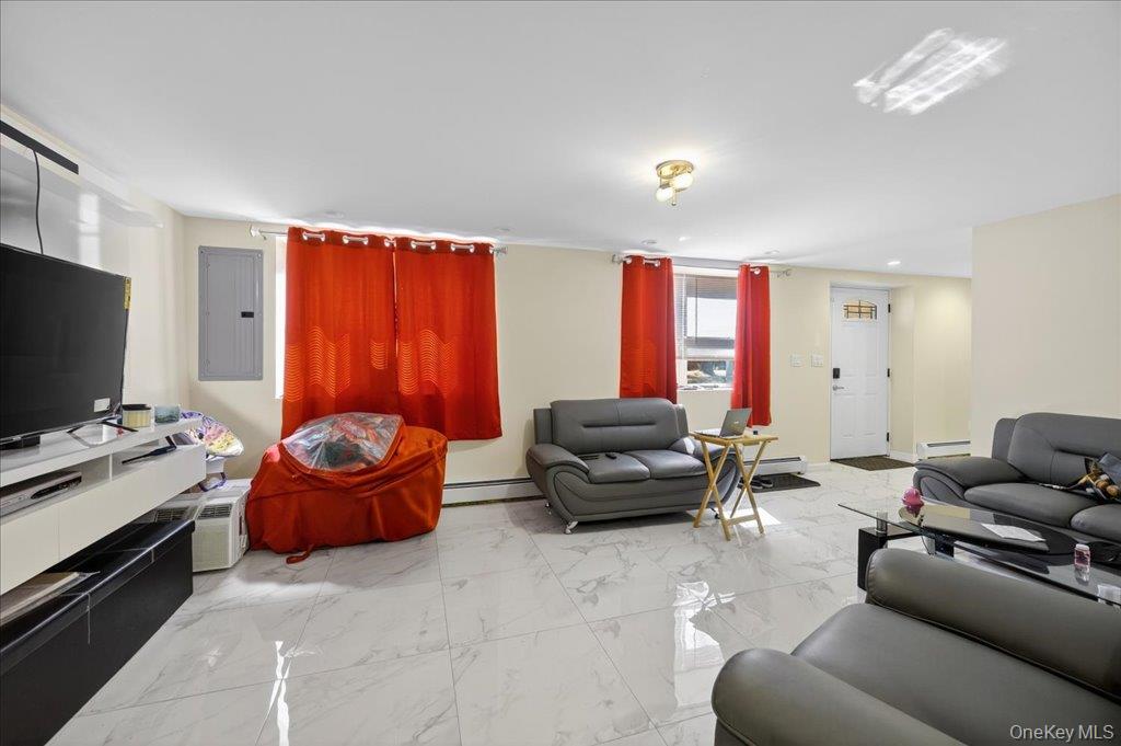 431 Gate Hill Coop Road Stony Point, NY 10980 - Photo 6 of 41 Living area with light marble finish flooring, electric panel, and a baseboard heating unit