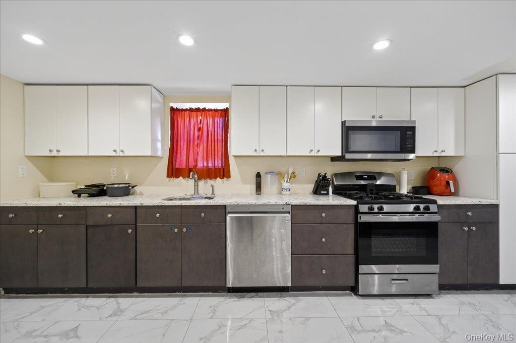 431 Gate Hill Coop Road Stony Point, NY 10980 - Photo 8 of 41 Kitchen with light marble finish floors, white cabinetry, appliances with stainless steel finishes, dark brown cabinetry, and recessed lighting