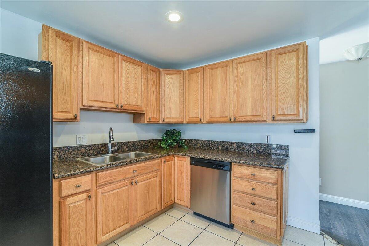 664 Moonglow Road Lompoc, CA 93436 - Photo 11 of 25 a kitchen with granite countertop white cabinets and stainless steel appliances