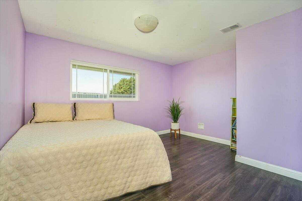 664 Moonglow Road Lompoc, CA 93436 - Photo 16 of 25 a bedroom with a bed window and wooden floor