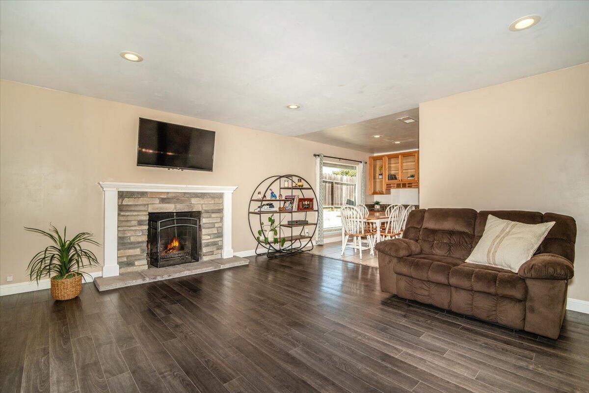 664 Moonglow Road Lompoc, CA 93436 - Photo 6 of 25 a living room with furniture a fireplace and a flat screen tv