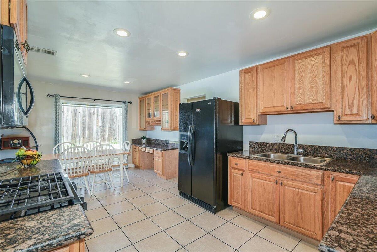 664 Moonglow Road Lompoc, CA 93436 - Photo 9 of 25 a kitchen with refrigerator and cabinets