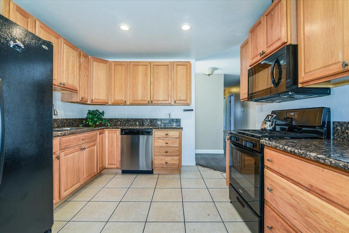 664 Moonglow Road Lompoc, CA 93436 - Photo 10 of 25 a kitchen with stainless steel appliances granite countertop a stove a sink and a microwave