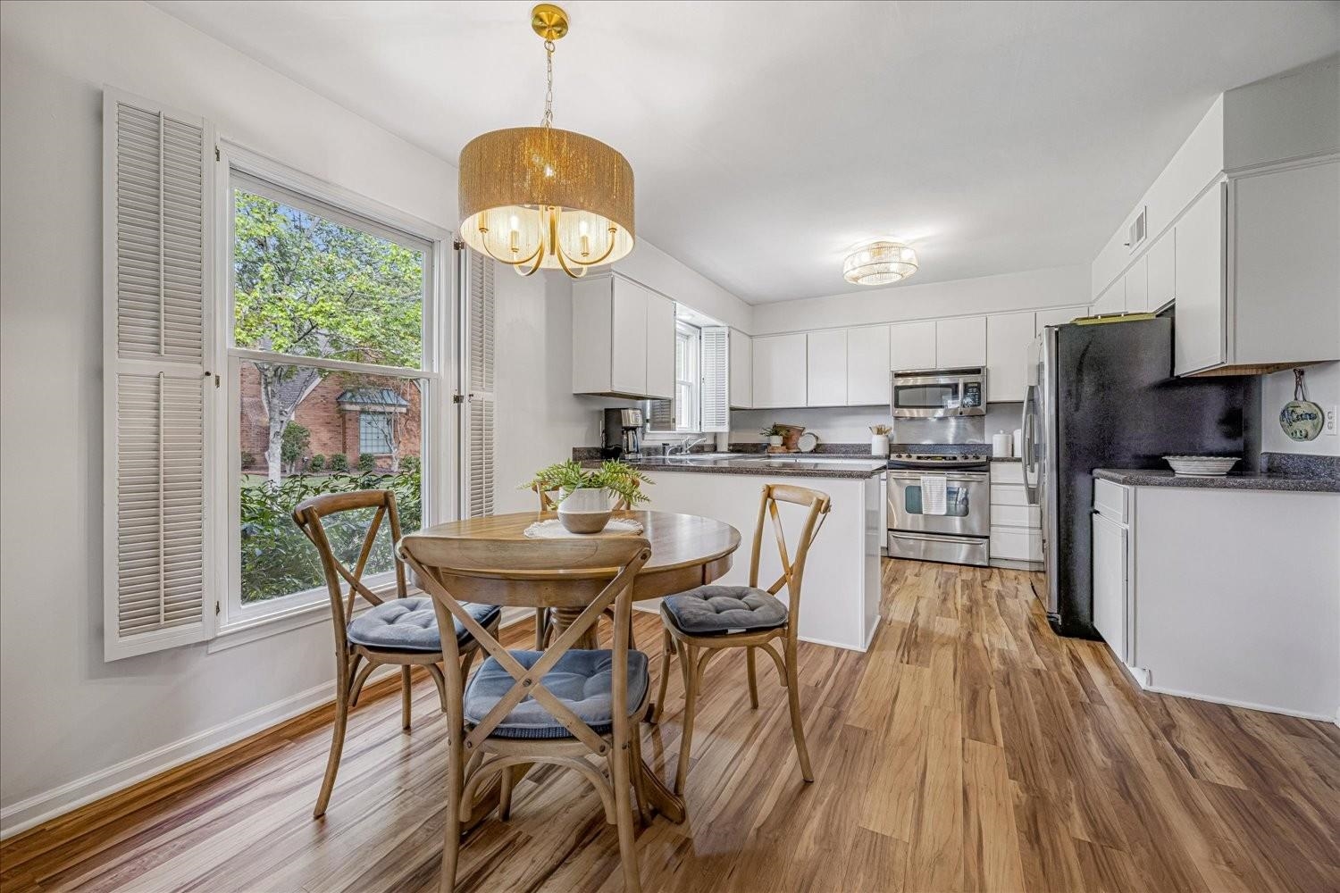 1893 Allenby Road Germantown, TN 38139 - Photo 14 of 31 a view of a dining room with furniture a chandelier and wooden floor