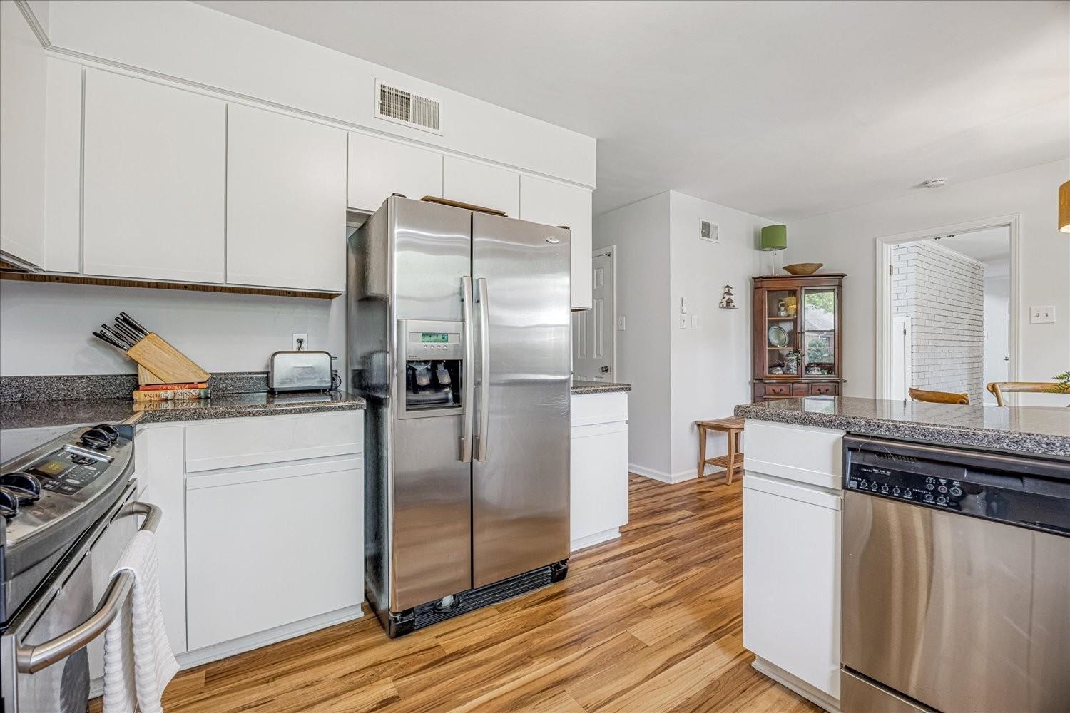 1893 Allenby Road Germantown, TN 38139 - Photo 16 of 31 a kitchen with stainless steel appliances granite countertop a refrigerator a stove and a sink with wooden floor