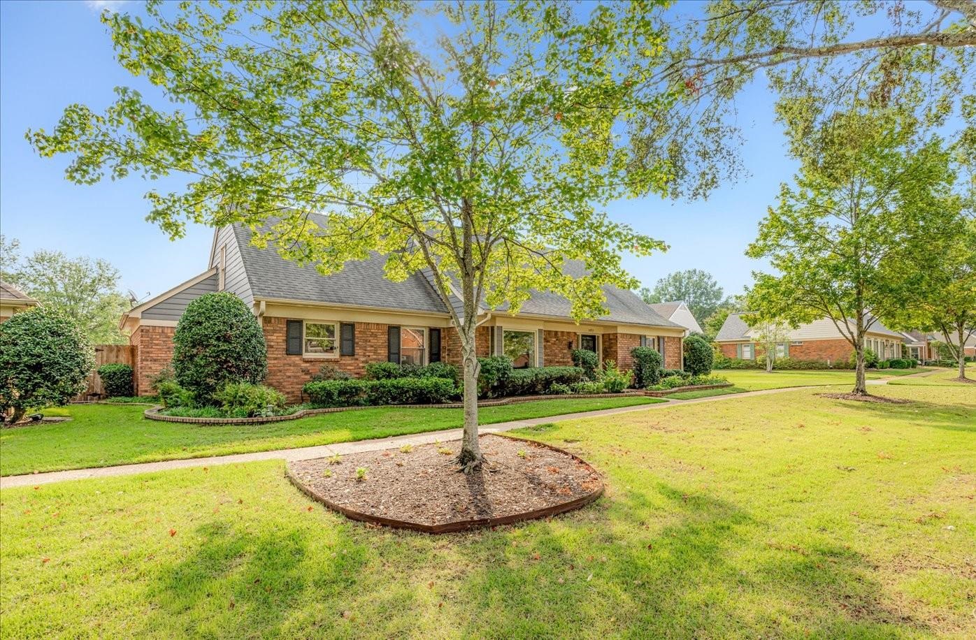 1893 Allenby Road Germantown, TN 38139 - Photo 3 of 31 a front view of a house with a yard garage and outdoor seating