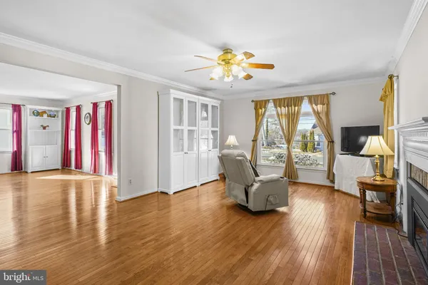 a view of a livingroom with furniture wooden floor and windows