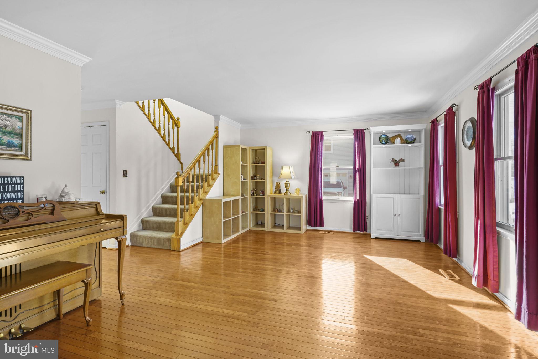 939 Main Street Deale, MD 20751 - Photo 14 of 33 a view of an empty room with wooden floor and stairs