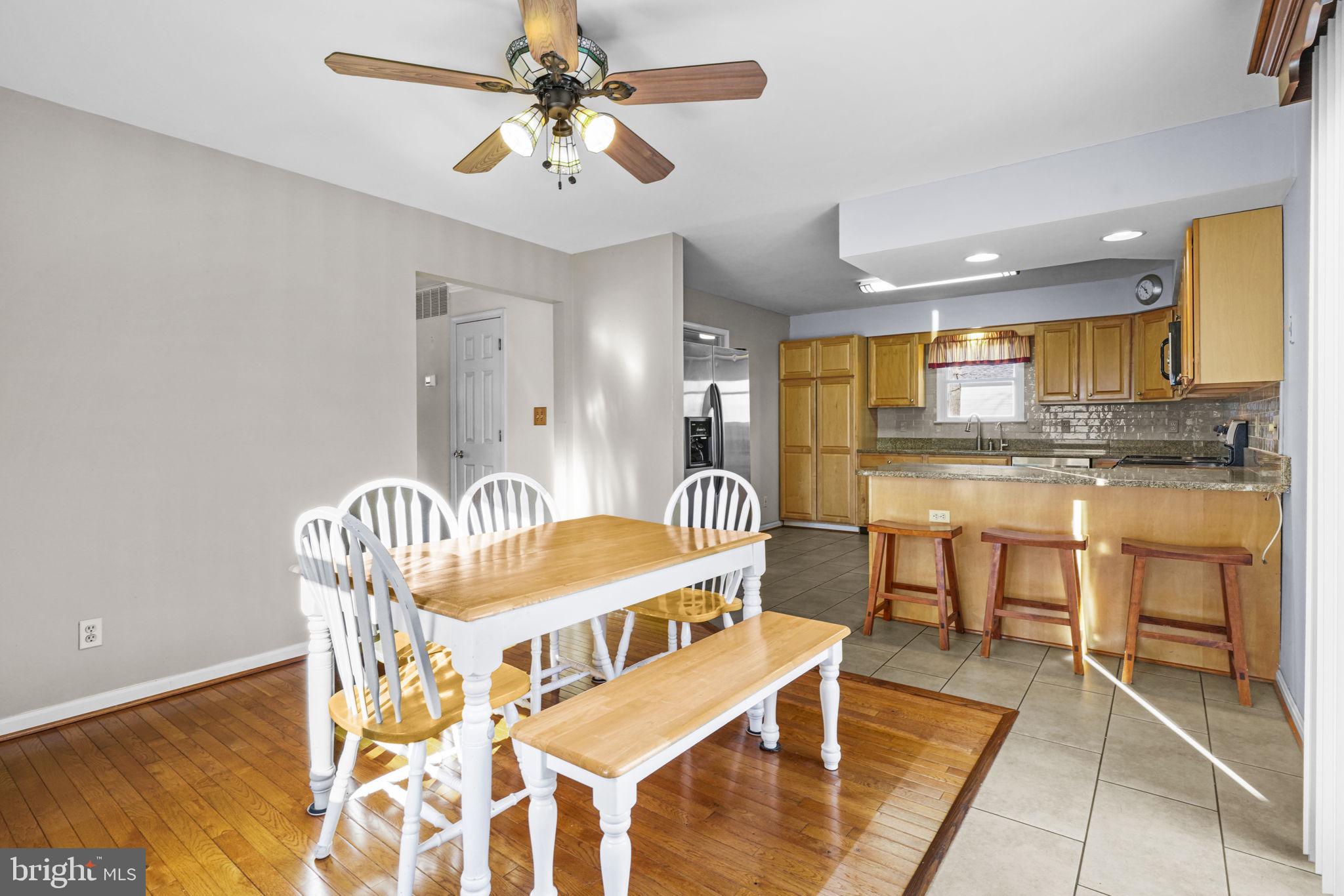 939 Main Street Deale, MD 20751 - Photo 21 of 37 a living room with stainless steel appliances kitchen island granite countertop furniture and a dining table