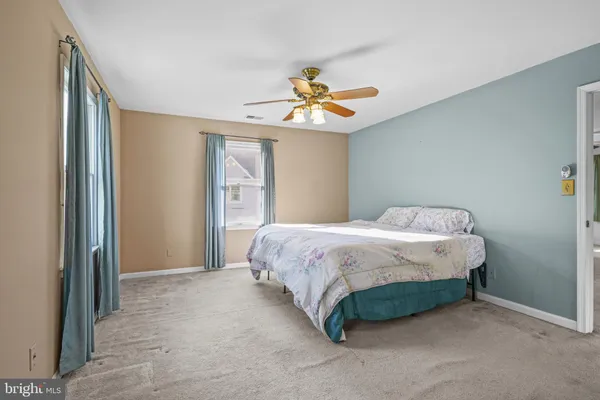 a spacious bedroom with a bed and a chandelier