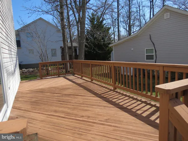 a view of a house with wooden deck