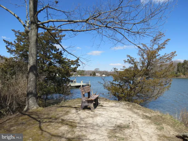 an aerial view of a house with outdoor space and lake view