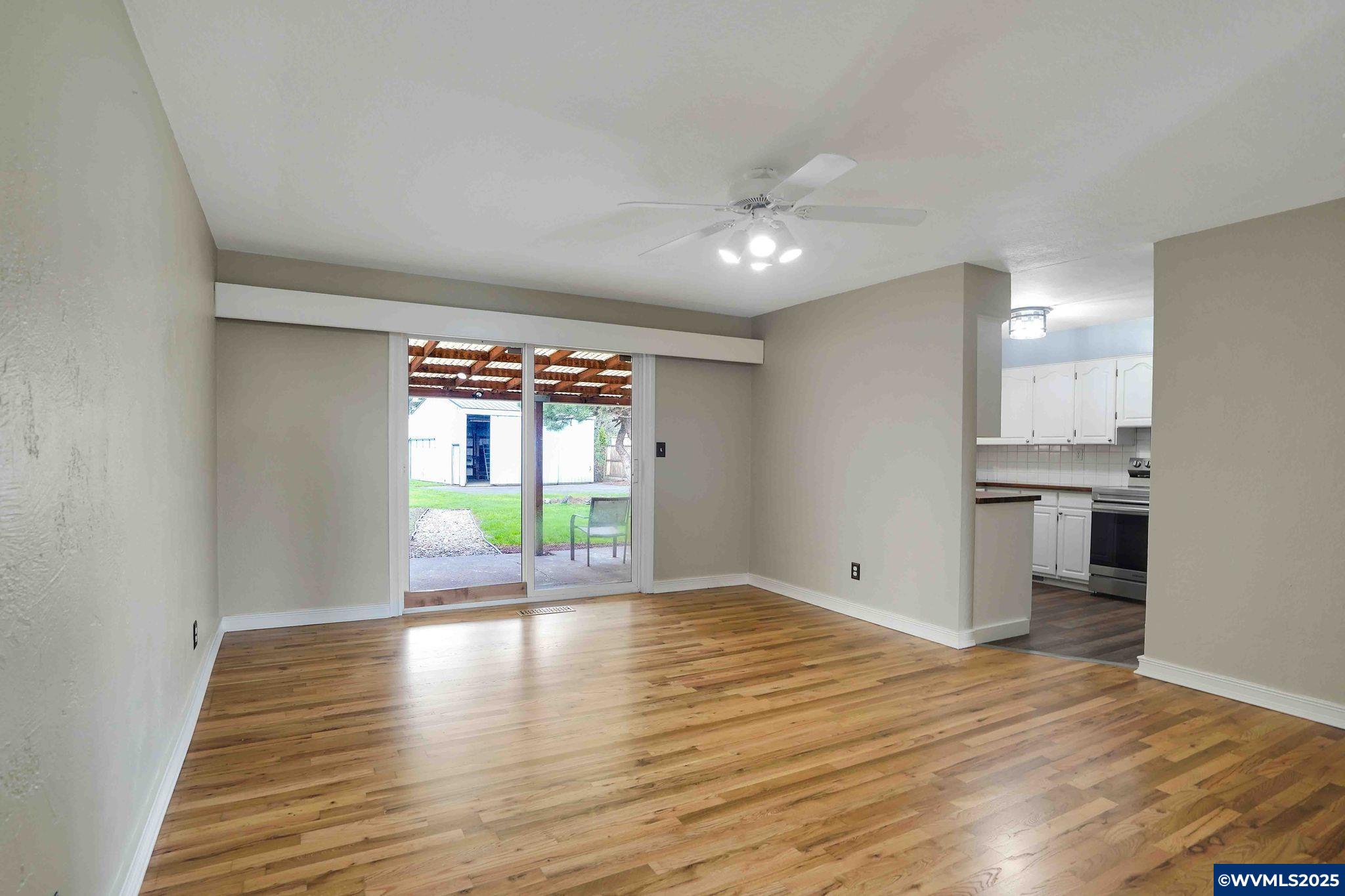 4843 Hazelgreen Road Northeast Salem, OR 97305 - Photo 14 of 48 a view of an empty room with window and wooden floor