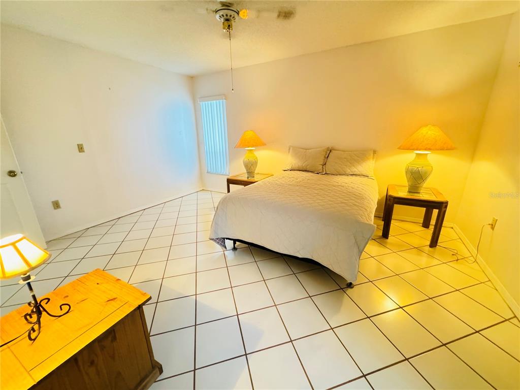 7559 Heather Walk Drive Weeki Wachee, FL 34613 - Photo 16 of 26 a bedroom with a bed and walk in closet